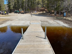 A lake access featuring a dock and two landings.